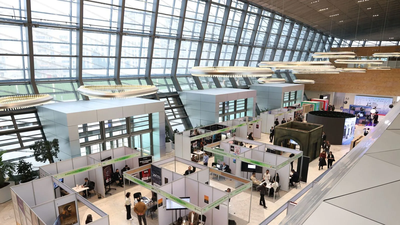 Trade-show hall with exhibition stands and visitors